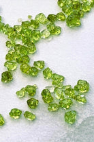 Peridot chips for candle making on a white background