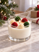 A candle made with pinecone wax molds on top on a Christmas background 