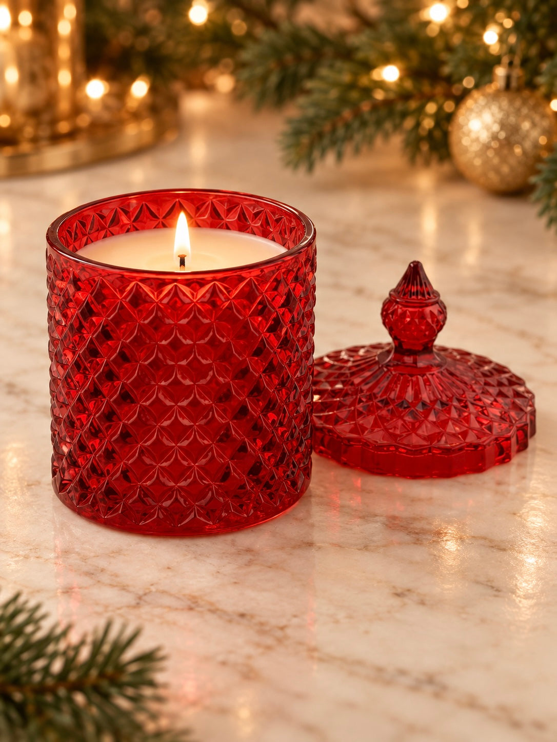 Geo cut red candle vessel with lid on a Christmas styled background 