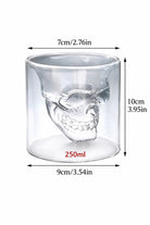 Glass skull shaped candle vessel with measurements on a white background