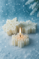 Snowflake Silicone Mold Canada | Snowflake shaped candles with one lit on a snowy background