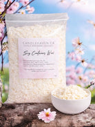 Bag of Candlehaven.ca soy container wax with a bowl of wax and flowers in the background
