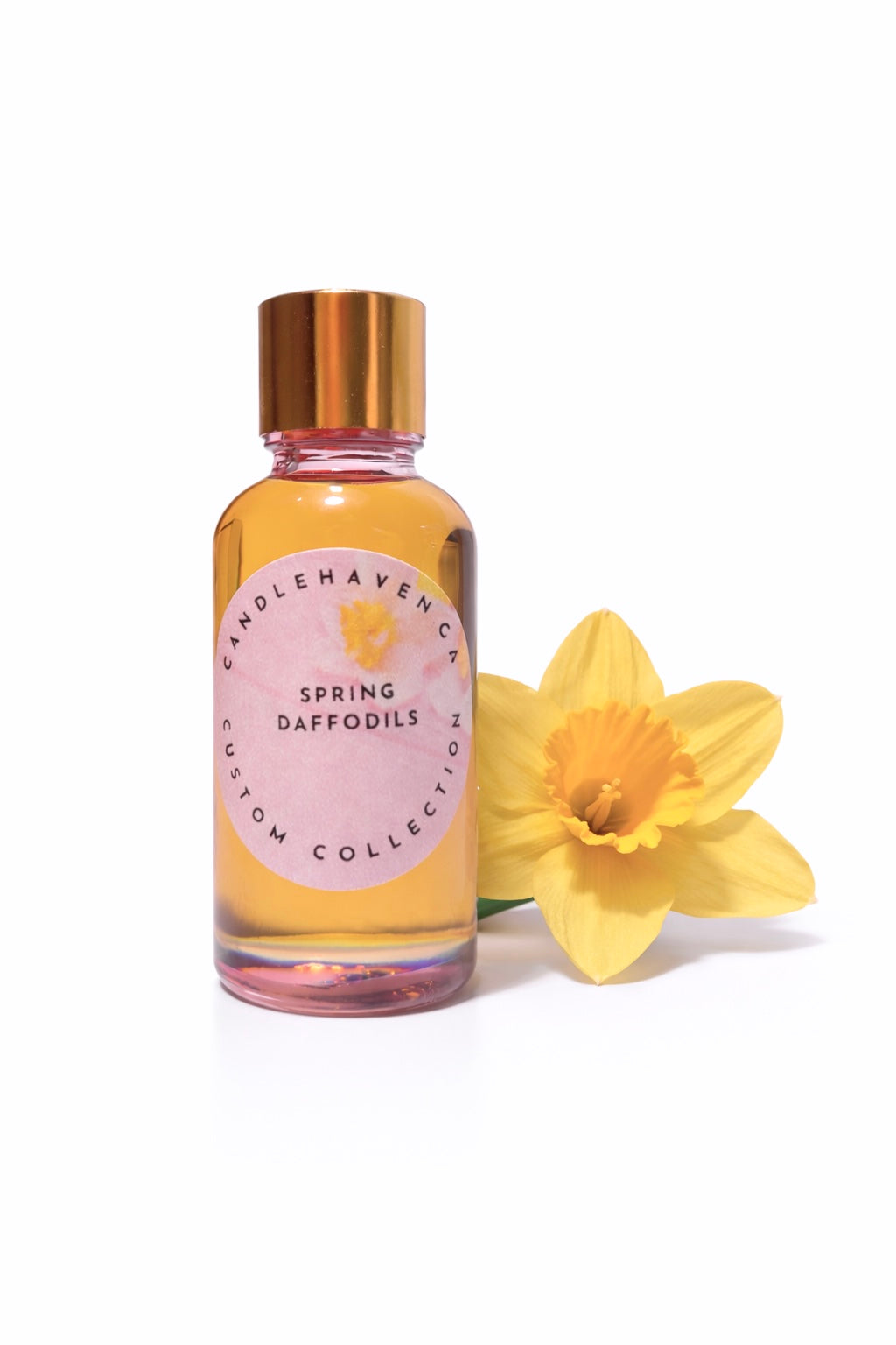 Bottle of 'Spring Daffodils' fragrance oil with a yellow daffodil on a white background
