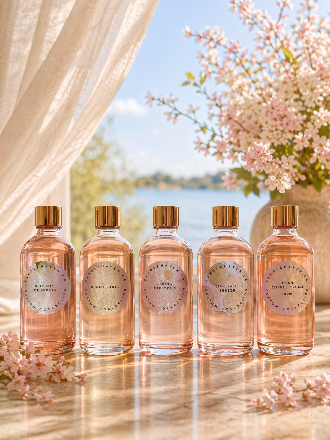 Five bottles of Candlehaven candle fragrance oils on a table with a scenic background