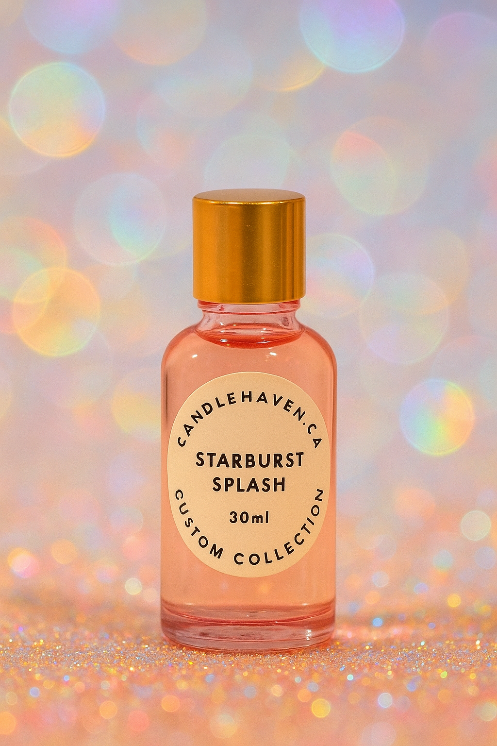 Bottle of 'Starburst Splash' fragrance oil with a gold cap on a colorful, blurred background