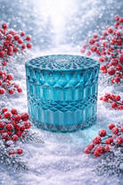 Teal glass vessel for candles | Teal geo-cut glass candle in a snowy setting with red berries