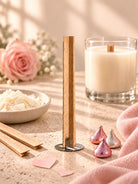 Wooden x wick in the forefront along with a couple
Chocolate kisses and a candle in the background and a rose 