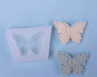 Butterfly-shaped silicone molds on a light blue background | silsicone reusable mold canada