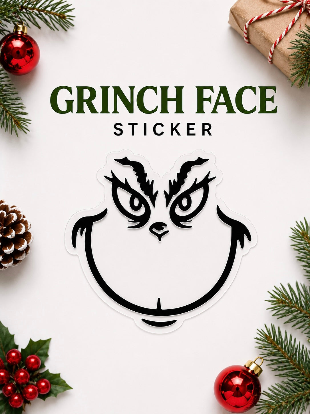 Grinch face sticker surrounded by Christmas decorations on a white background
