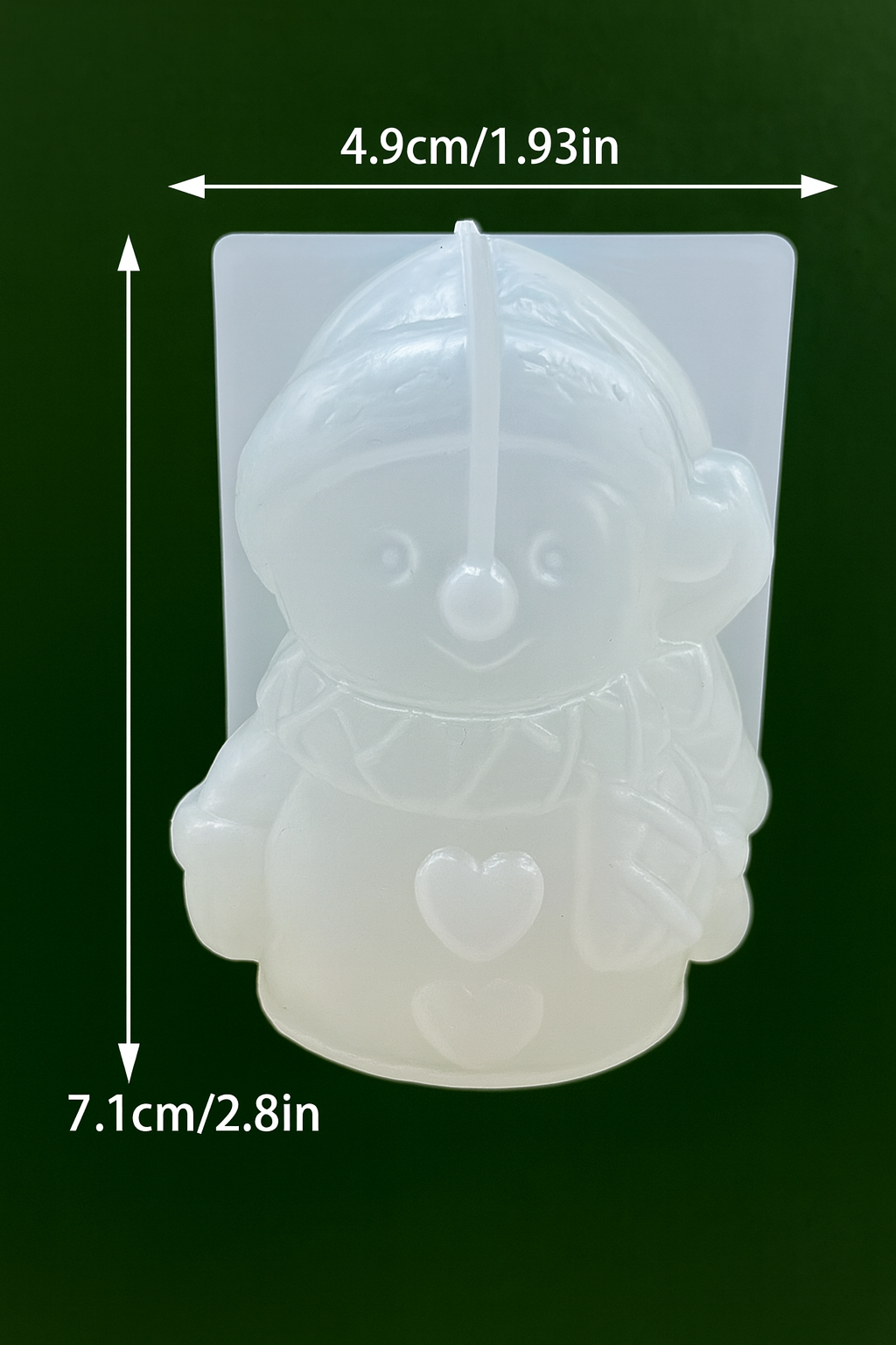 Silicone mold shaped like a character with dimensions indicated on a dark background used in candle making in Canada