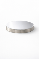 Round metallic lid for a candle jar on a white background
